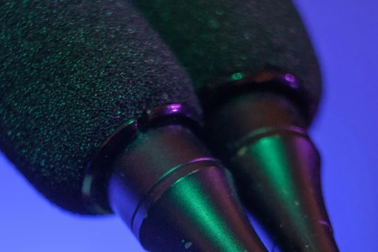 Two microphones on a blue background