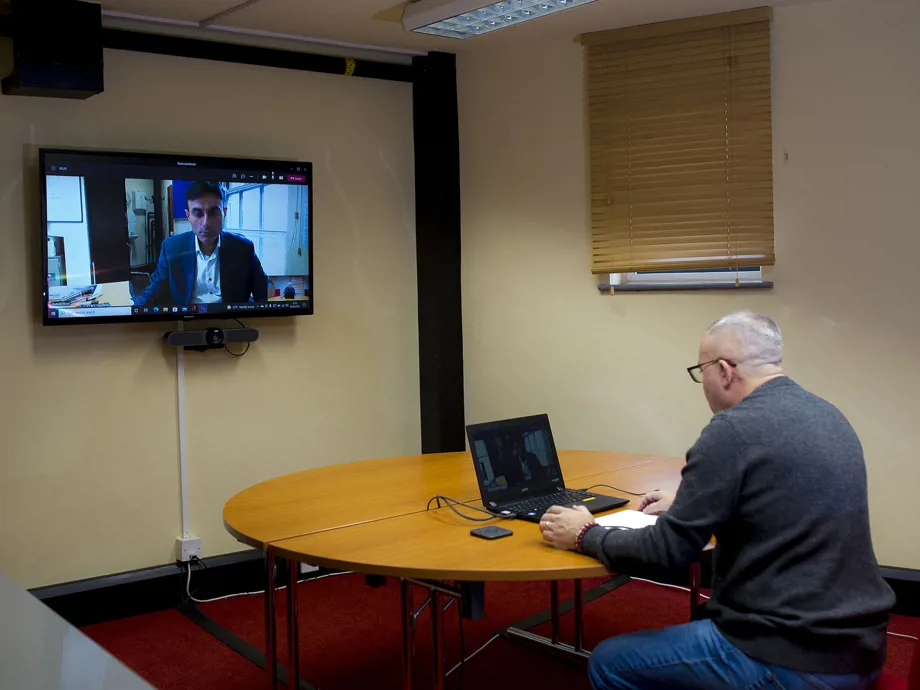 Person using video conferencing in Brindley Room