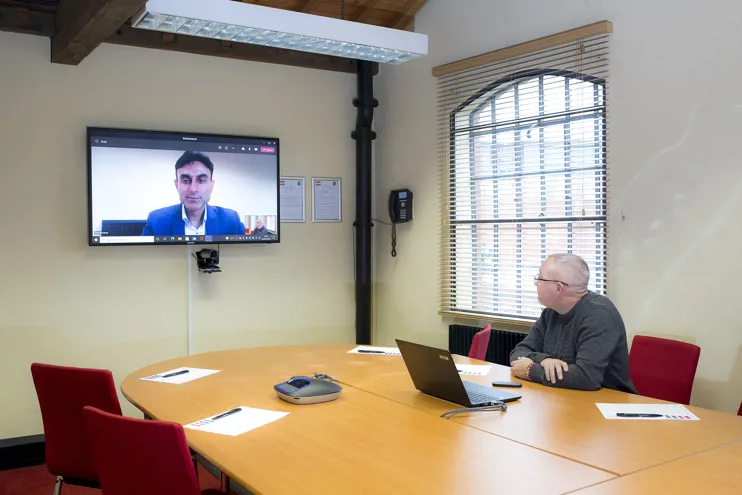 Person using video conferencing in Randall Room